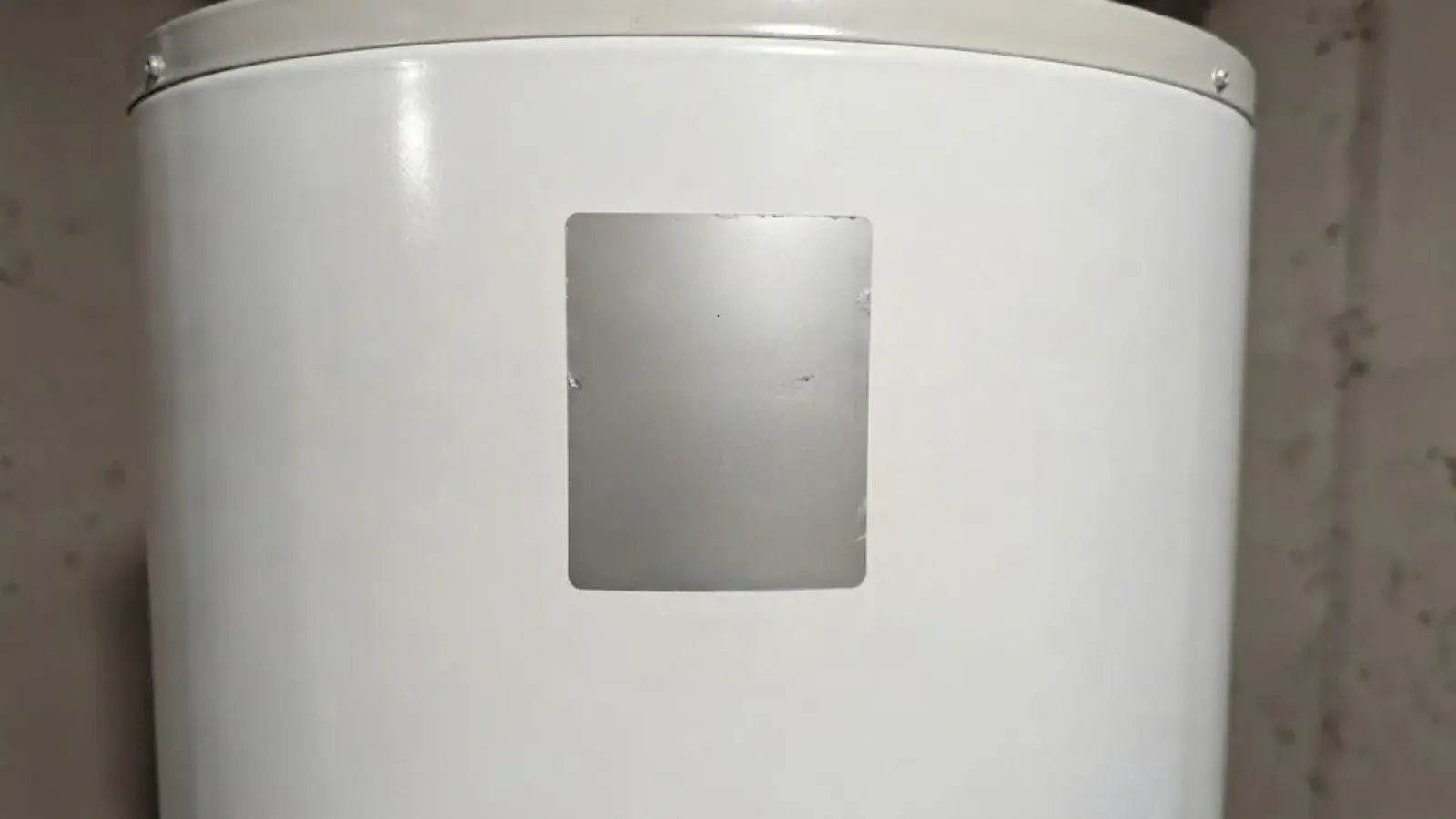Older water heater tank in a basement utility area